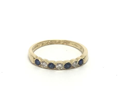 An 18ct gold sapphire and diamond half eternity ring, approx 2.4g nd approx size O.