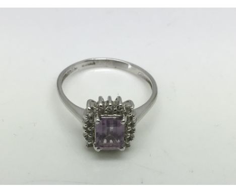 A 9ct white gold ring set with an amethyst type stone surrounded by diamonds, approx 2.6g and approx size N.