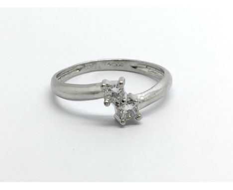 An 18carat white gold ring set with two diamonds approximately 0.20 of a carat. ring size M.