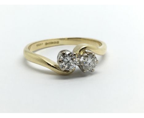 An 18ct gold two stone diamond ring, approx .40ct, approx 2.6g and approx size J.