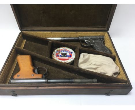 Two vintage Diana .177 air pistols. One with wooden handle, both in a fitted wooden gun box