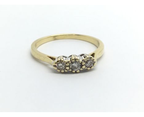 An 18ct gold three stone diamond ring, approx .20ct, approx 2.6g and approx size M-N.