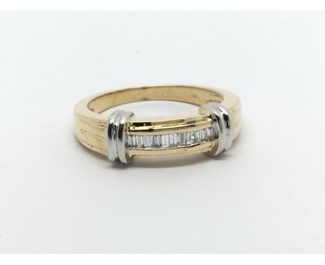 An 18carat gold ring set with emerald cut diamonds flanked by white gold bands ring size M.