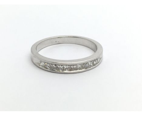 An 18ct white gold half eternity diamond ring set with princess cut diamonds, approx.25ct, approx 2.7g and approx size K.