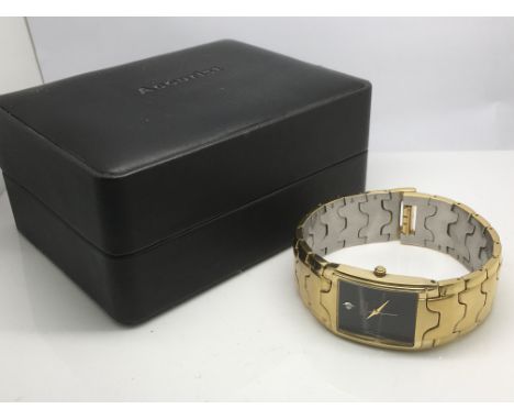 A gents Accurist watch with a black face and set with a small diamond.