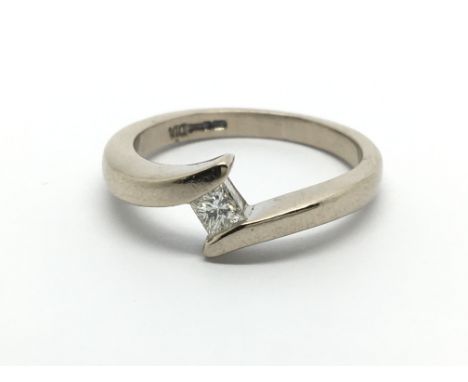 An 18carat gold ring inset with a solitaire Princess cut diamond approximately 0.15 of a carat ring size L-M