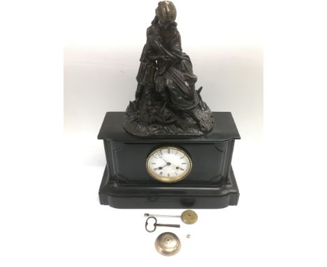 A French 8 day black slate mantle clock surmounted with a female figure, with key and pendulum.