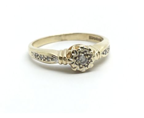 An 18ct gold solitaire diamond ring with further diamonds to the shoulders, approx 2.2g and approx size L-M.