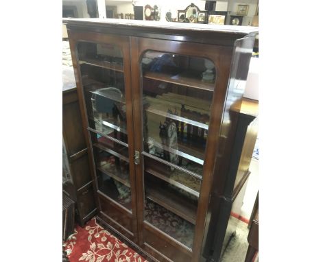 A Edwardian mahogany two door book case with fitted shelfs on a plinth base - NO RESERVE