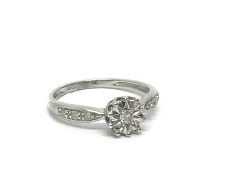 A 9ct white gold solitaire diamond ring with further diamonds to the shoulders, approx 1.5g and approx size H-I.