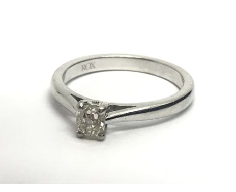 An 18ct white gold solitaire diamond ring set with a aingle princess cut diamond, approx .33ct, approx 4.6g and approx size M