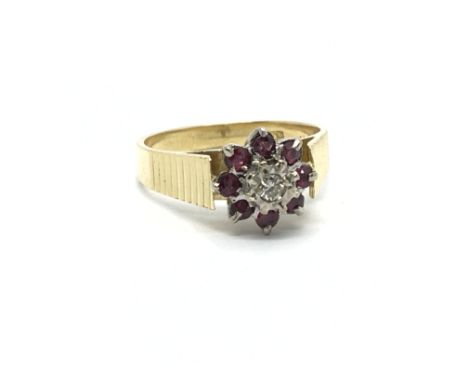 An 18carat gold ring set with a pattern of ruby and diamonds. Ring size O.