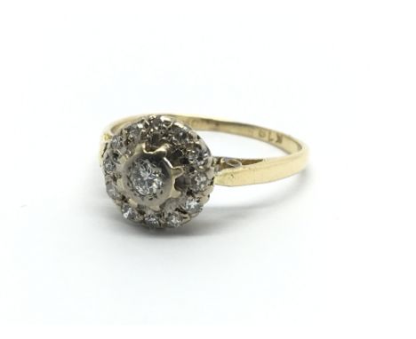 An 18carat gold ring set with a circular pattern of diamonds ring size K.