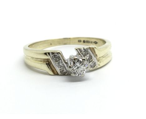 A 9ct gold solitaire diamond ring with further diamonds to the shoulders, approx .15ct, approx 2.9g and approx size O-P.