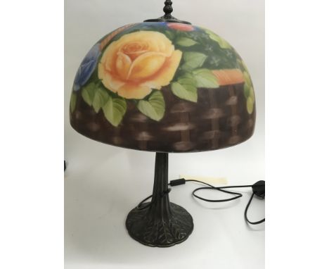 A glass side lamp the shade decorated with flowers and foliage.