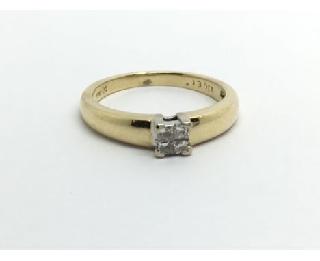 An 18carat gold ring set with a square of Princess cut diamonds ring size I-J.