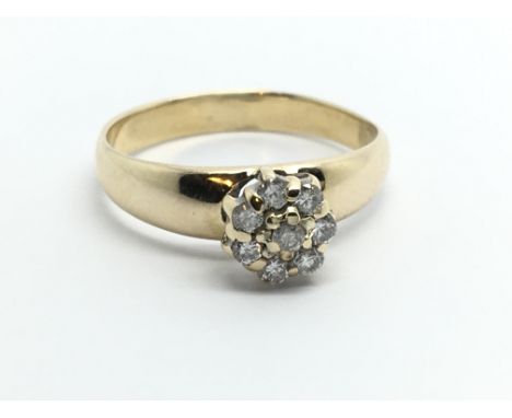 An unmarked yellow metal ring set with eight diamonds in a flowerhead setting, approx 2.2g and approx size N.