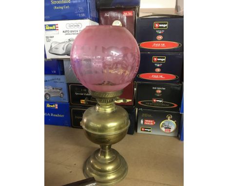 A Victorian style oil lamp with cranberry shade - NO RESERVE