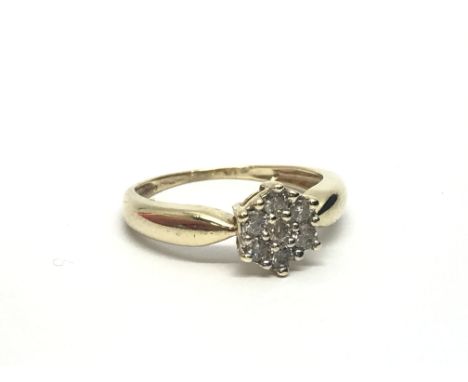 A 9ct gold seven stone diamond cluster ring, approx .25ct, approx 1.7g and approx size K-L.