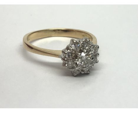 An 18ct gold nine stone diamond cluster ring in the form of a flowerhead, approx 1/2ct, approx 2.9g and approx size J-K.