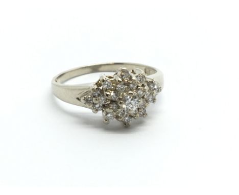 A 14ct white gold diamond cluster ring, approx .33ct, approx 2.2g and approx size J-K.