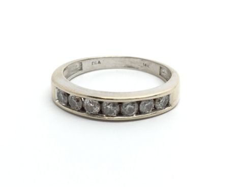 An 18ct white gold seven stone half eternity ring, approx 2.9g and approx size J.