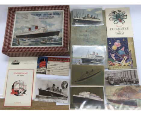 A collection of vintage Cunard cruising items including a jigsaw of the 'Queen Elizabeth', postcards etc.