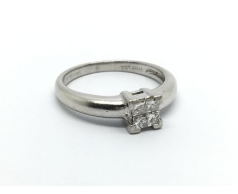 A Platinum ring set with princess cut diamonds approximately 0.20 of a carat ring size J.