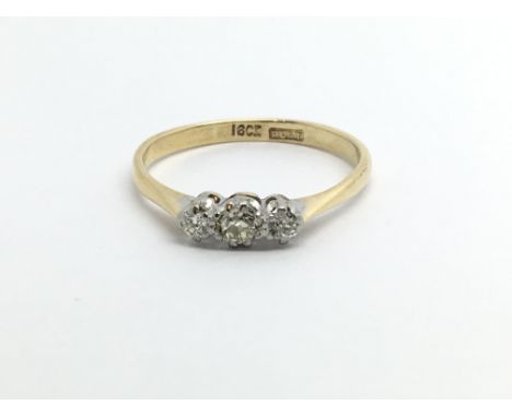 An 18ct gold three stone diamond ring, approx .20ct, approx 2g and approx size N.