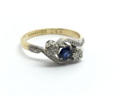 An 18carat gold and platinum ring set with a blue sapphire and diamonds. Ring size I.