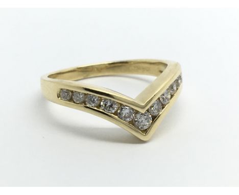 An 18carat gold ring of wishbone shape set with brilliant cut diamonds ring size K-L.