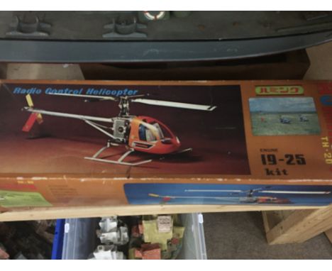 A collection of vintage remote control vehicles boats and helicopters. See image.