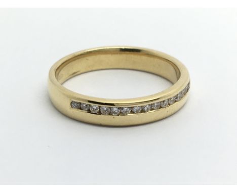 An 18carat gold ring set with a row of diamonds. Ring size O.