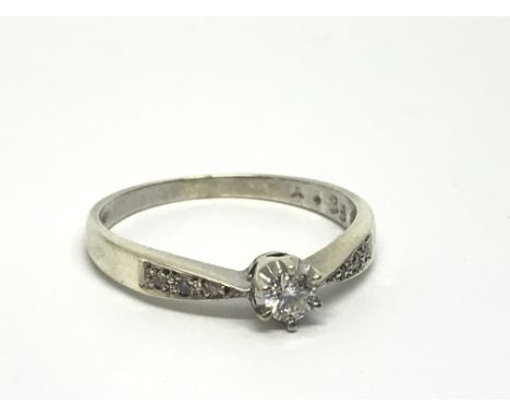 A 9ct white gold solitaire diamond ring with further diamonds to the shoulders, approx.15ct, approx 2.3g and approx size P.