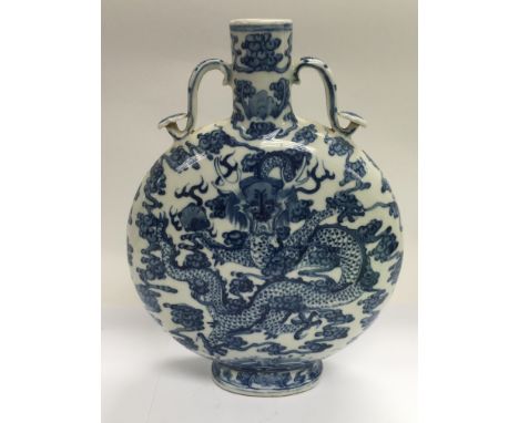 A blue and white moon flask decorated with dragons and with character marks to the base, approx height 26.5cm.