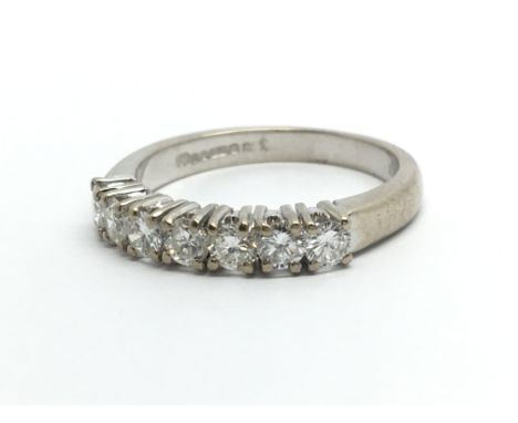 An 18ct white gold seven stone half eternity ring, approx 3.6g and approx size K-L.