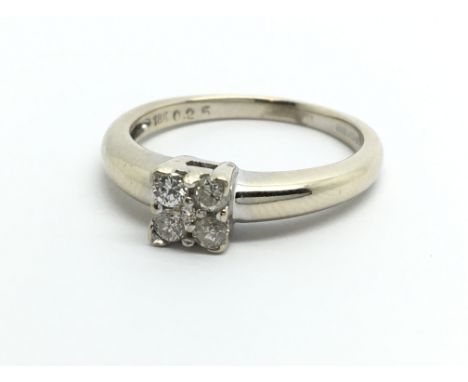 An 18ct white gold ring set with four diamonds and one smaller to the centre, aporox 1/4ct, approx 4g and approx size P.