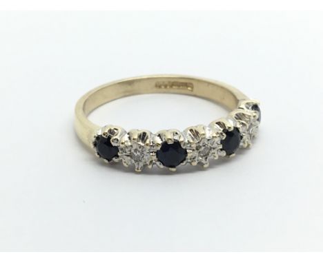 A 9carat gold ring set with alternating sapphire and diamonds ring size K.