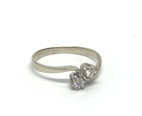 A 14ct white gold ring set with two diamonds, approx .15ct, approx 1.4g and approx size K.