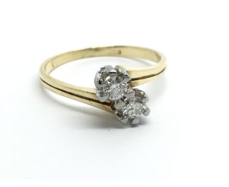 An 18carat yellow gold ring two diamond crossover approximately 0.25 of a carat ring size J-K