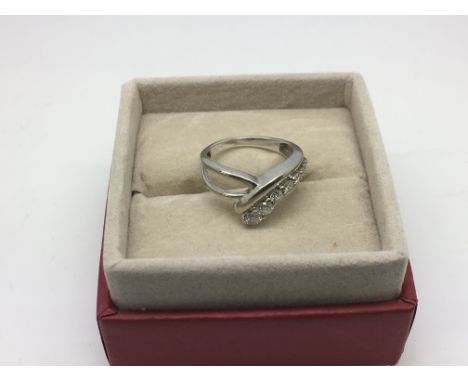 A 10k white gold ring with graduating brilliant cut diamonds, approx 2.7g and approx size K.