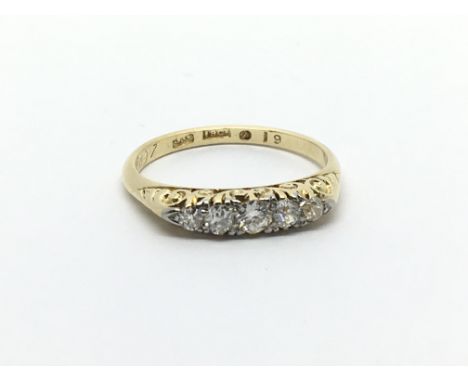 A Vintage 18carat gold ring set with a pattern of five diamonds. Ring size L