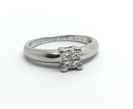 A platinum ring set with four princess cut diamonds, approx .20ct, approx 4.8g and approx size K-L.