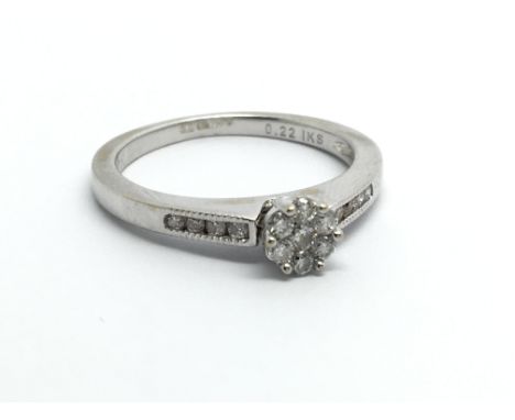 An 18carat white gold ring set with a pattern of brilliant cut diamonds the shank with further diamonds ring size K-L