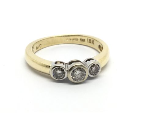 An 18carat gold ring set with three brilliant diamonds ring size M.