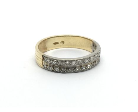 An 18carat gold ring set with two rows of small diamonds. Ring size M.