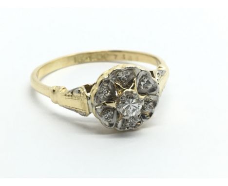 An 18ct gold seven stone diamond cluster ring, approx 3.1g and approx size P-Q.