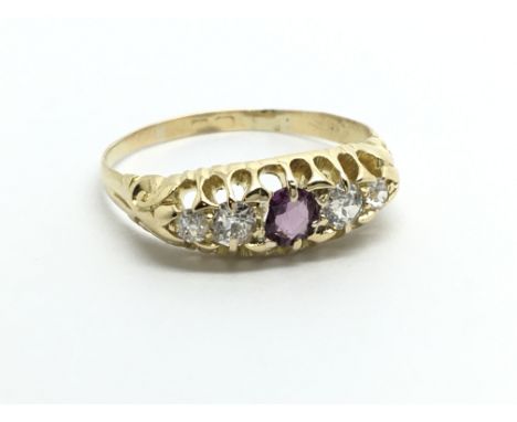 A vintage 18ct gold ring set with four diamonds and an amethyst, approx 2.8g and approx size O.