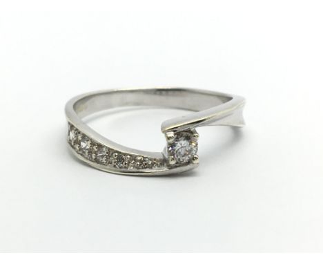 A 9ct white gold solitaire diamond ring with further diamonds to the shoulders, approx 2.3g and approx size M.
