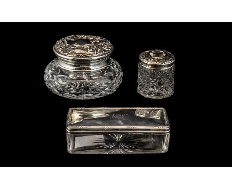 Three Silver Topped Glass Dressing Table Trinket Boxes, comprising a hair tidy, powder box and lidded trinket box.  Circa 191